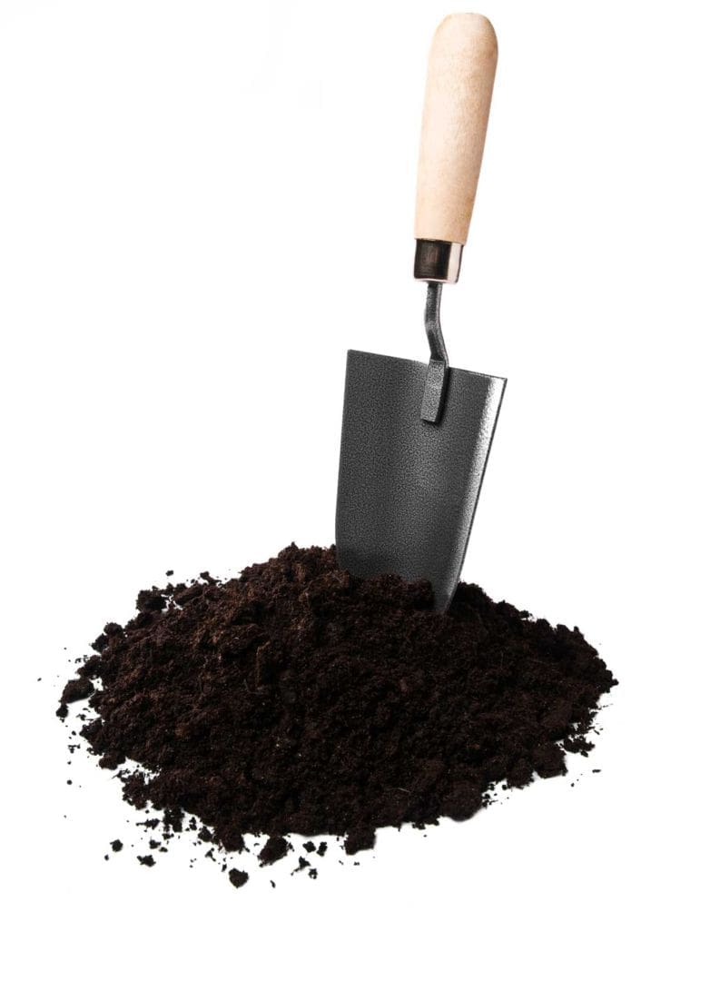 Trowel with soil. Hsu Growing supply offers pickup or delivery of soil mulch and compost in Wausau