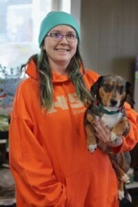 Wholesale Rep, Betsy Heidt, holds her dog Muppy in our retail store.